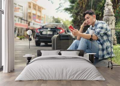 Asian man waiting for Uber taxi Wall mural