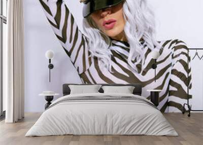 sexy androgenic model in freak stylish zebra print clothes and leather trendy black cap posing in a white studio. Clubbing party style Wall mural