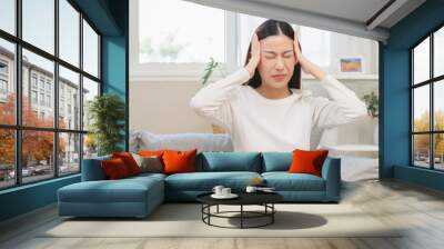 Brain stroke or low blood pressure symptom on people medical concept. Young beautiful woman has a dizziness and motion blurry during standing off sofa at home Wall mural