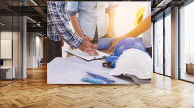 Builder team meeting and planning for renovation office project. worker contractor talking with architect and discussing about job. Wall mural