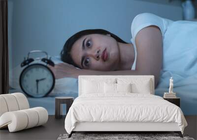 Close-up alarm Young Asian woman have insomnia on the bed Wall mural