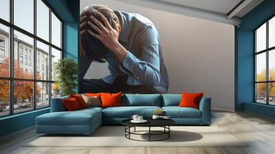 depressed teenage man sitting on the floor have a bullying problem at school Wall mural