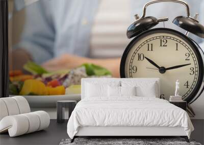 Intermittent fasting concept, Close-up on clock and people feeling hungry waiting time to eat during intermittent fasting diet session Wall mural