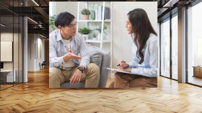 Man talking with mentor psychologist in therapy mental health anxiety session. Wall mural