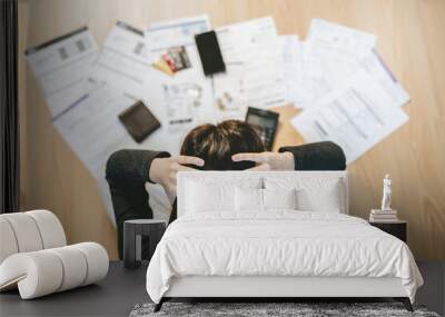 Top view of stressed young asian woman trying to find money to pay credit card debt. Wall mural