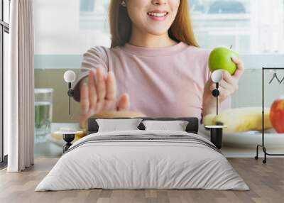 Woman on dieting for good health concept. Woman doing cross arms sign to refuse junk food or fast food (hamburger and potato fried) that have many fat. Wall mural