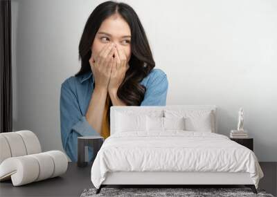 Young woman feeling embarrassed covering her face with her hands Wall mural