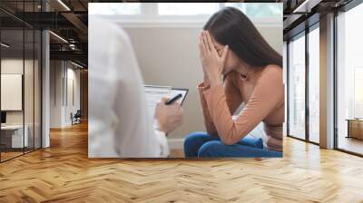 Young woman in a mental therapy session talking with a psychologist in the office. Wall mural