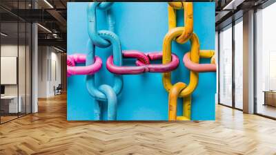 Abstract image of four colorful chains connecting, creating a pattern on a blue background. Wall mural