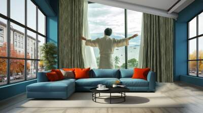 Behide asian man in bathrobe suit open curtain to see view outside in morning, Travel and Holiday concept Wall mural