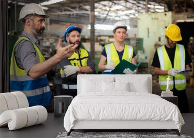 professional caucasian manager engineer in safety uniform is training industry factory worker, works Wall mural