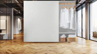 White clothes hanging neatly on wooden hangers in an open closet, minimalist laundry, clean and modern design Wall mural