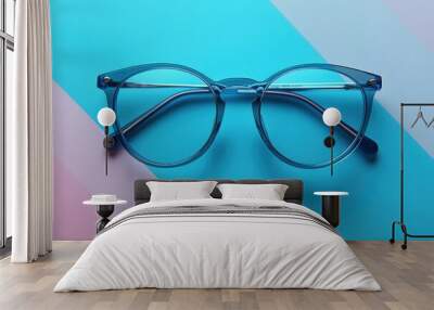 Stylish Blue Transparent Eyeglasses on a Vibrant Blue and Pink Striped Background Wall mural