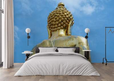 Big golden Buddha statue on a bright sky background - Landmark Famous sculpture statue in Thailand Temple. Wall mural