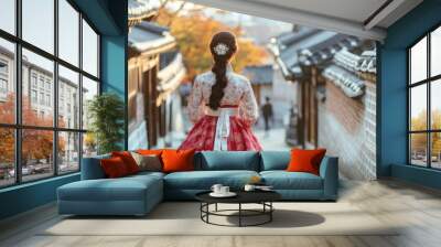 Back view of korean asian woman in traditional korean dress or hanbok dress walking in old palace in night with full moon, Seoul city, South Korea,copy space. Wall mural