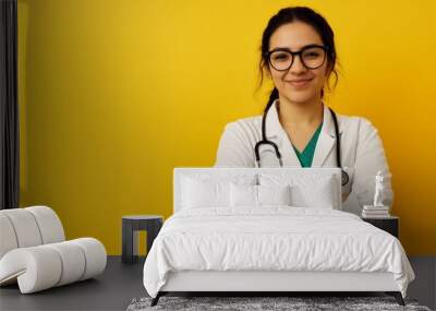 Smiling Female Doctor with Stethoscope on Yellow Background Wall mural