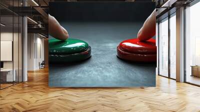 Close-up of two fingers pressing red and green buttons on a dark surface, symbolizing choice, decision-making, or competition. Wall mural