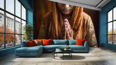 Close-up of a young Muslim woman hands in prayer, intricate henna designs Wall mural