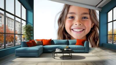 Smiling young girl with cheerful expression in close-up portrait. Child joy and innocence. Wall mural