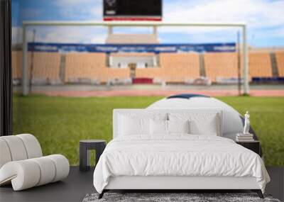 A soccer ball in front of goal Wall mural