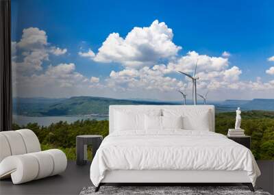 Wind turbine on the vast grassland with mountains and sky as a background in Nakhon Ratchasima Thailand. Wall mural