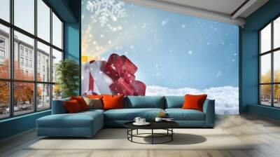 Christmas gift box on snow Wall mural