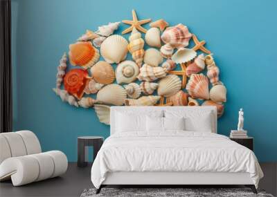 A creative arrangement of seashells resembling a brain on a blue background, symbolizing ideas and creativity from the ocean. Wall mural