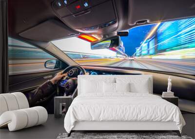 Movement of the car at night at high speed view from the interior with driver hands on wheel. Concept spped of life. Wall mural