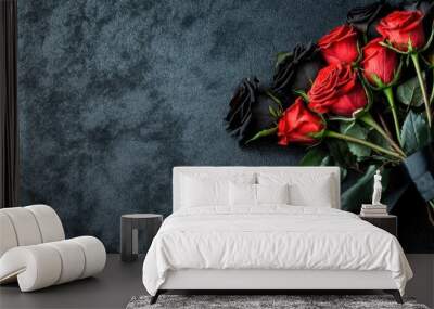 Black silk ribbon tied around a bouquet of red and black roses, laying on a dark velvet backdrop Wall mural