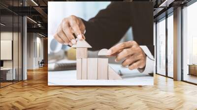 Close-up midsection of businessperson making house model with wooden blocks on construction plan Wall mural