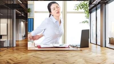 Asian businesswoman fell tired and stretching Wall mural