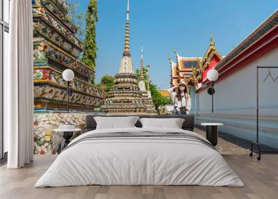 female tourist girl visiting famous wat pho temple Wall mural