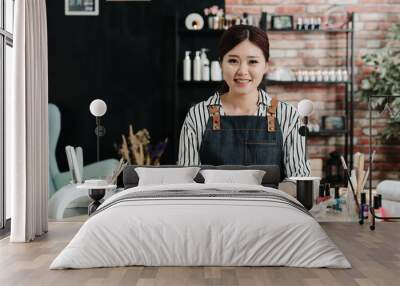 Portrait of asian korean manicurist in spa salon. successful confident beauty salon female owners looking at camera sitting in studio. Cheerful beautician smiling and waiting for client in workshop. Wall mural