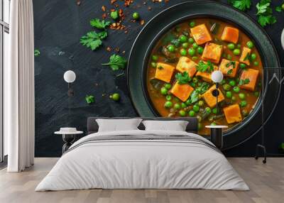 Top view of green peas and cheese cube curry or matar paneer curry recipe served in a bowl, a delicious and flavorful main course Wall mural