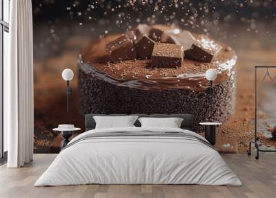 A close-up shot of a decadent chocolate cake with chocolate chunks and cocoa powder. Wall mural