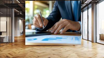 Closeup of a business advisor pointing at financial projections on a tablet, providing guidance on postacquisition growth, financial growth, business advice Wall mural