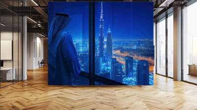 Arab man sheikh businessman gazes out the window of a skyscraper at a vast modern city with tall buildings Wall mural