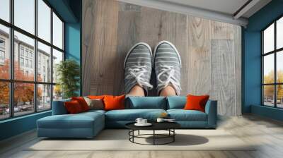 Top view selfie of feet in stylish sneakers on a wooden floor with space for text emphasizing public distancing Wall mural