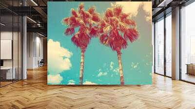 Tropical palm trees on blue sky background with sun rays, vintage filter effect Wall mural