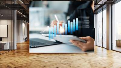 Businesswoman analyzing company's business financial balance sheet working with digital augmented reality graphics, Businesswoman calculates financial data for long-term investment. Wall mural