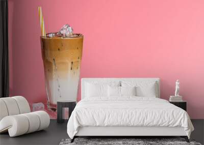 Summer drink background, copy space. Glass of sweet creamy iced coffee , espresso coffee with milk with straw isolated on pink background.	 Wall mural