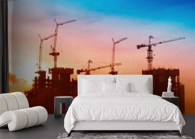 Industrial landscape with silhouettes of cranes on the sunrise b Wall mural