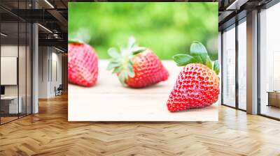 Strawberries with blurry green background Wall mural