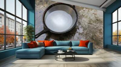 washing frying pan with water on the cement floor Wall mural