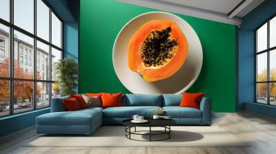 fresh cut of papaya in white plate at green background Wall mural