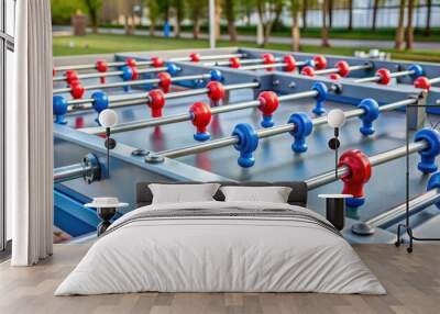 Stable gray foosball game with red and blue players for kids at play area near the blue crane in Offenbach Wall mural