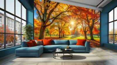 Warm sunlight shining through colorful autumn trees in a peaceful park setting Wall mural