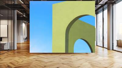 Abstract architecture background of green Tuscany arches wall against blue sky in perspective side view and vertical frame Wall mural