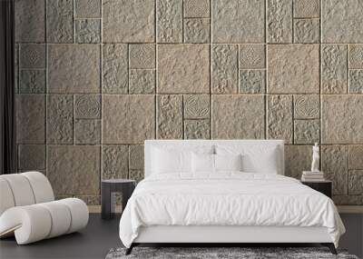 Beige stone tile exterior wall background with abstract pattern and rough texture surface on pavement floor Wall mural