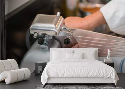 chef wearing rubber glove  using ham slicer machine Wall mural